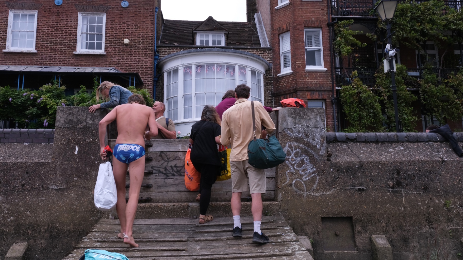 Swimmers climbing out after a river swim