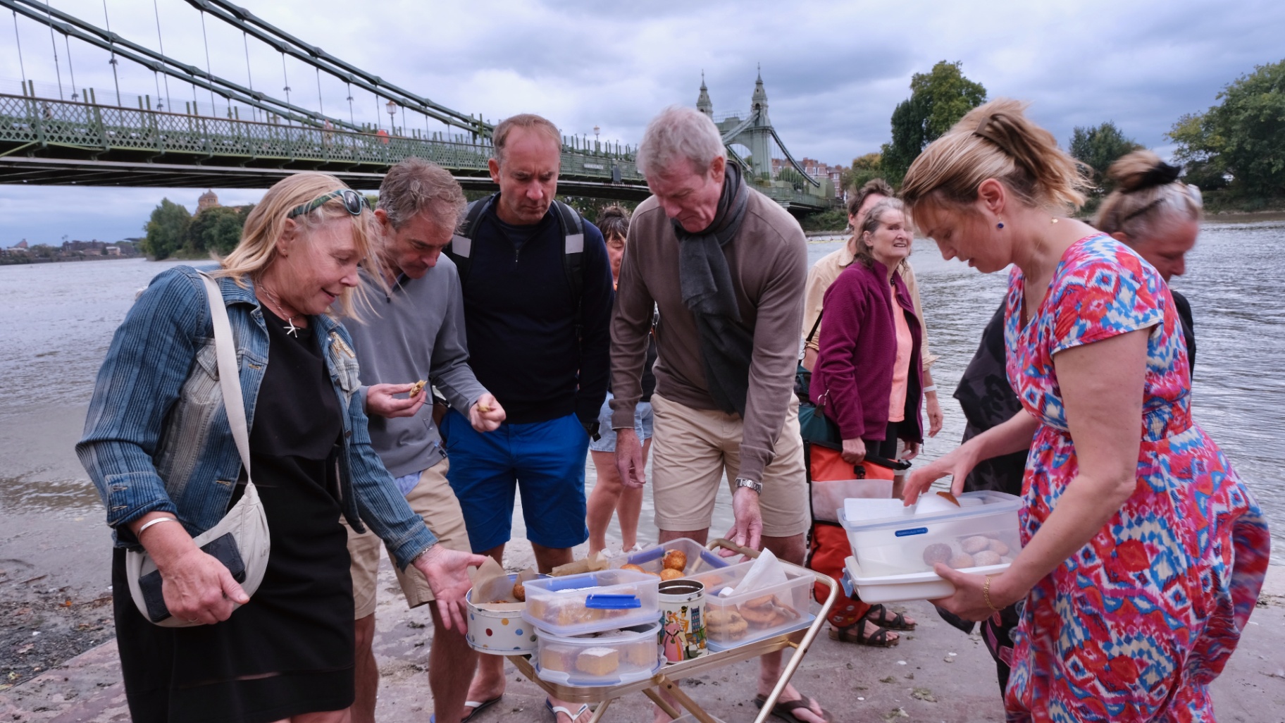 A wide view of the riverside gathering before or after swimming