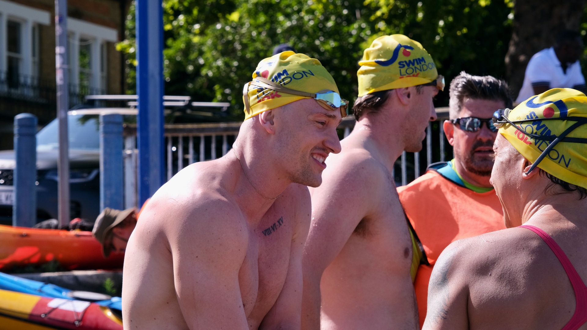 Swimmers wearing Swim London yellow caps preparing for the swim