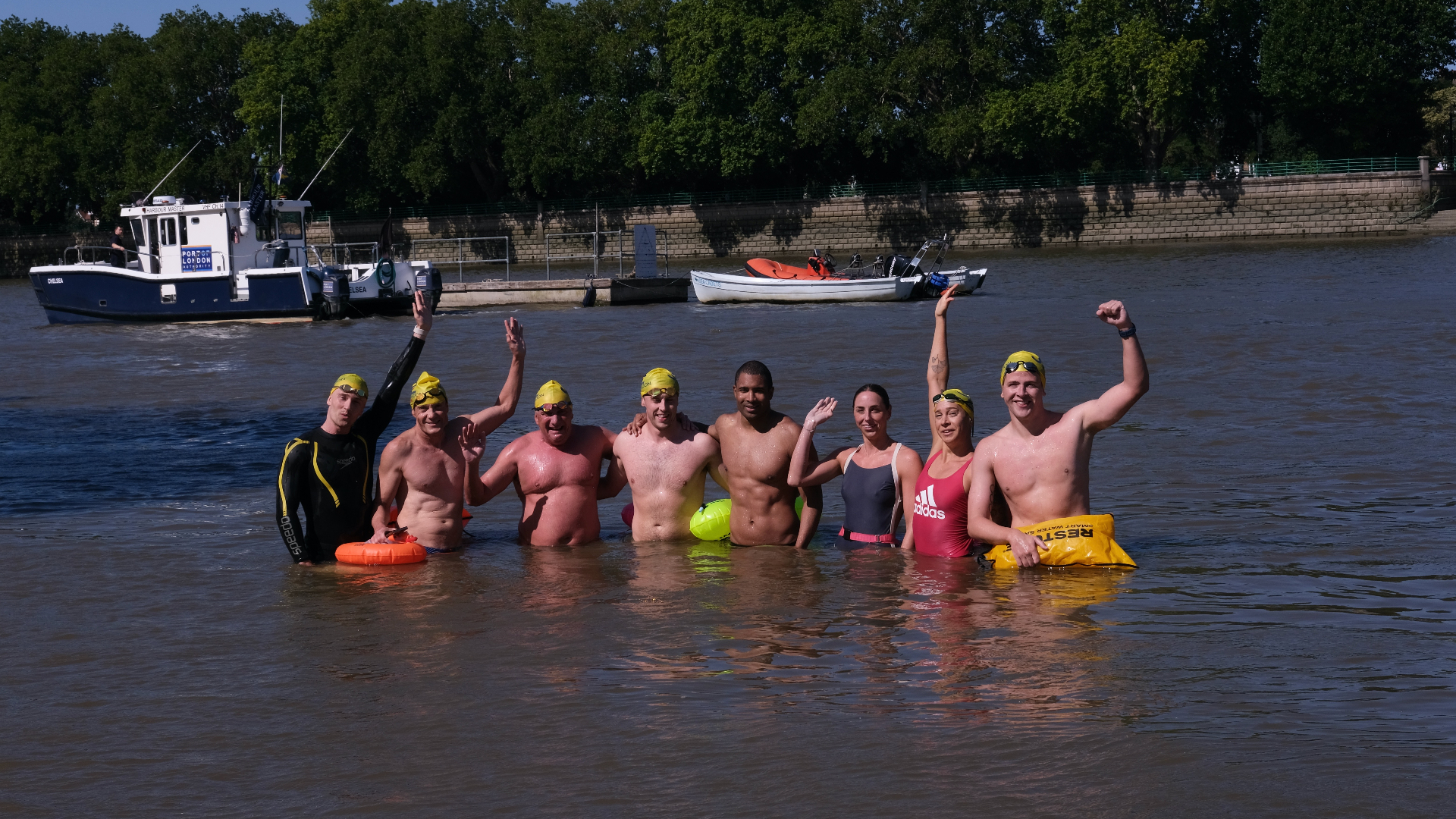 Swimmers celebrating together in the Thames after a session