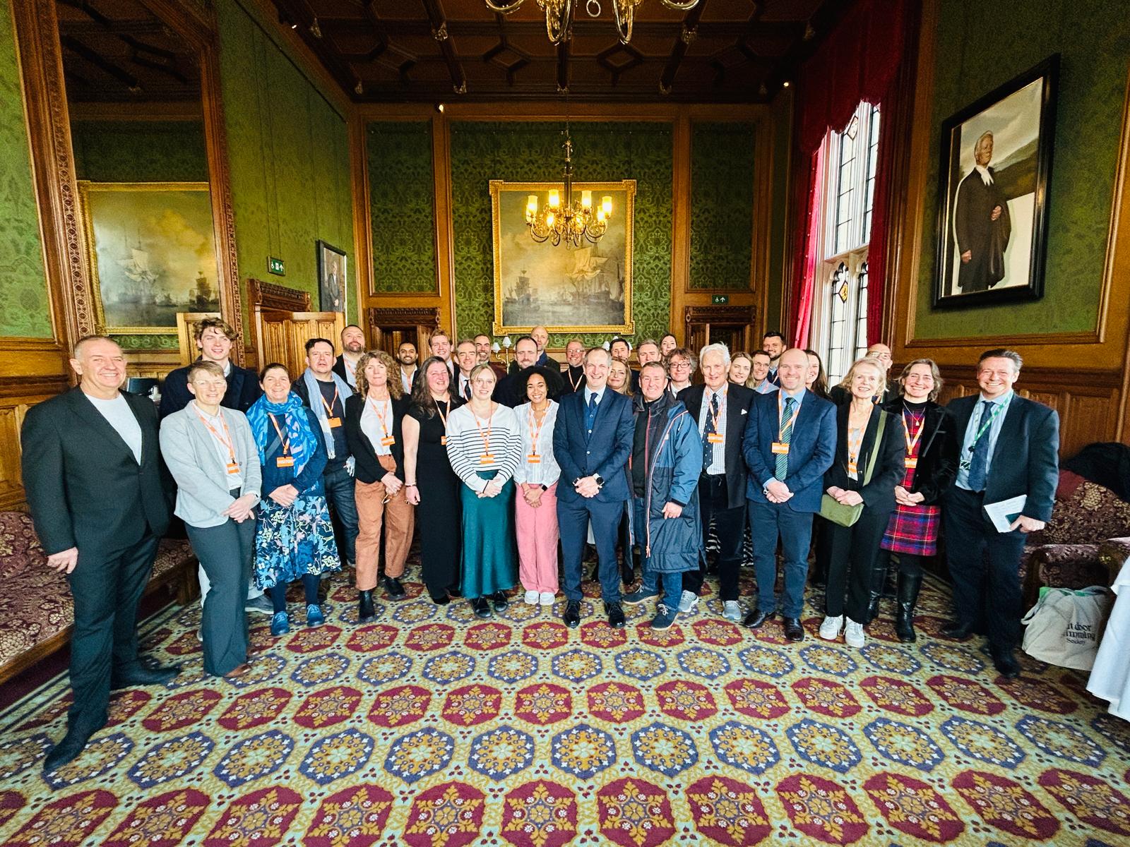 A large planning group gathered in a historic wood-panelled room
