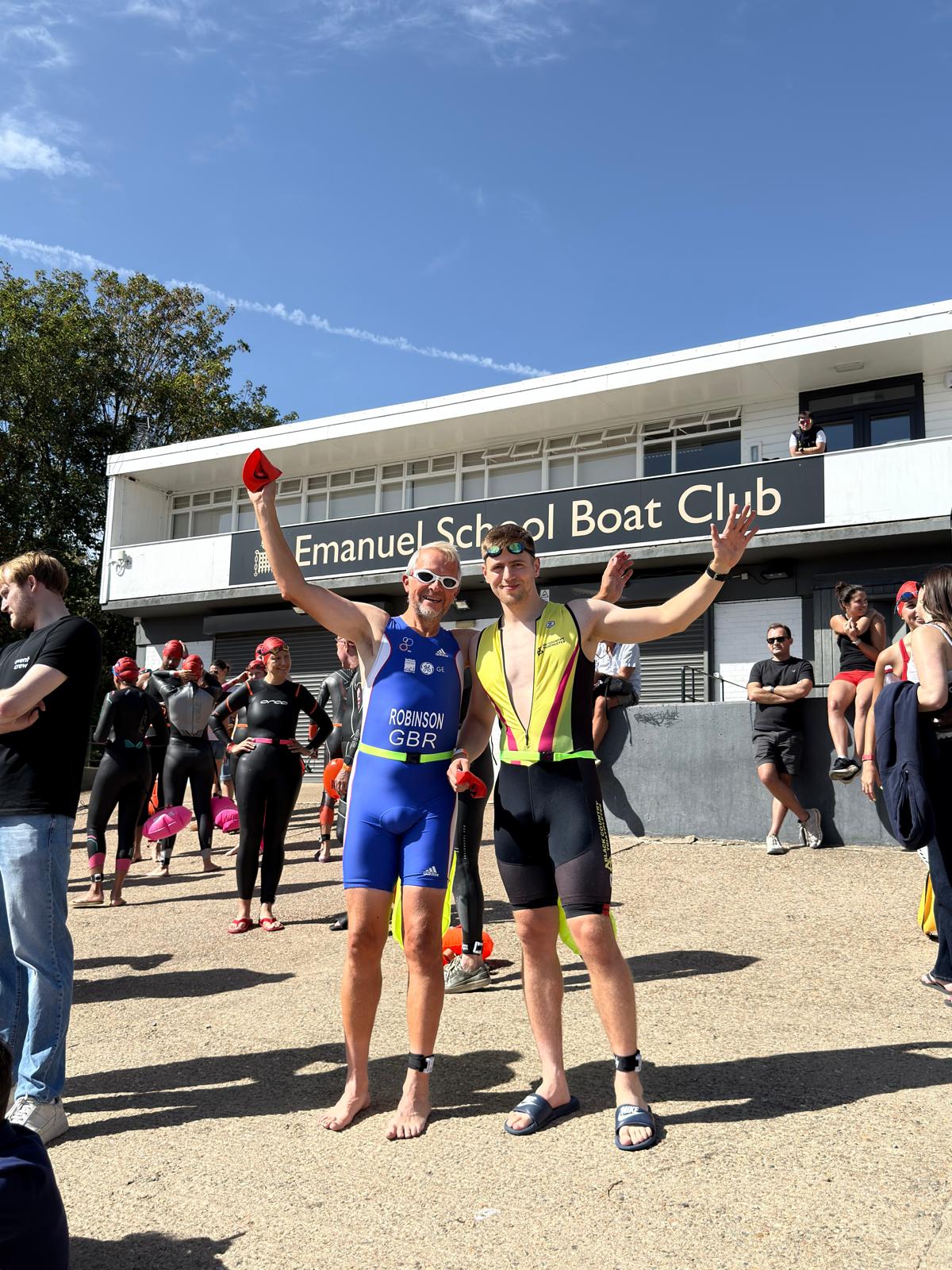 Two swimmers celebrating outside Emanuel School Boat Club before the Barnes start