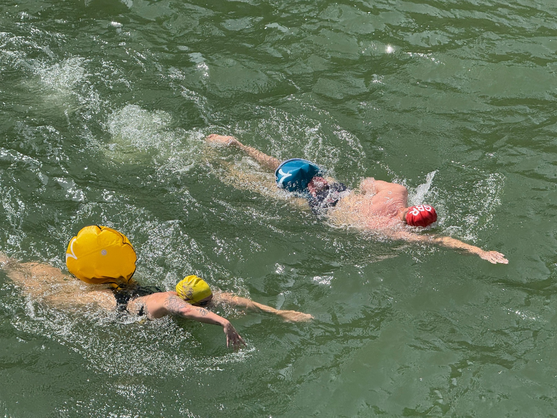 Open-water swimmers spread across the Thames