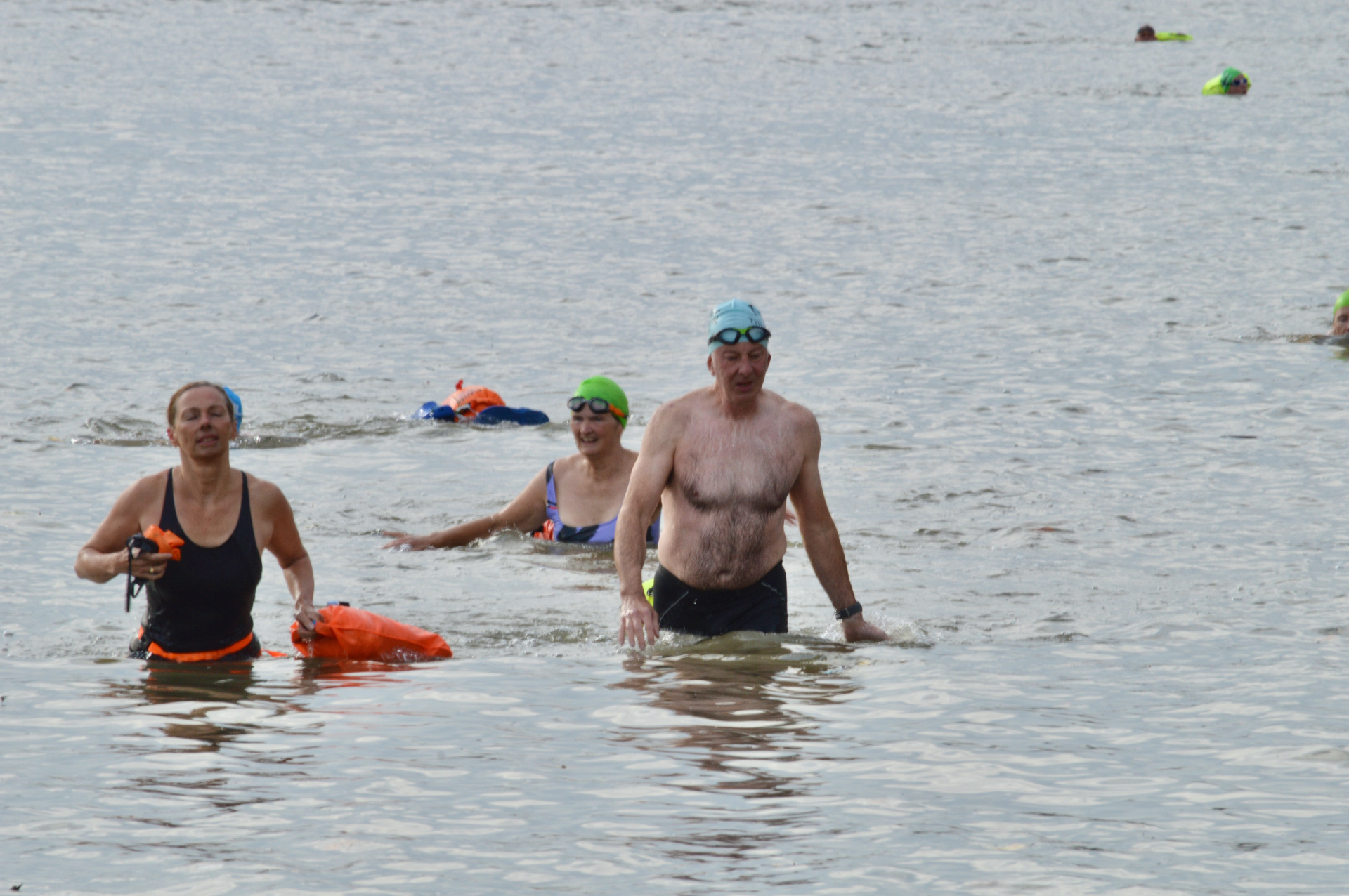 Open-water swimmers wading through the Thames together